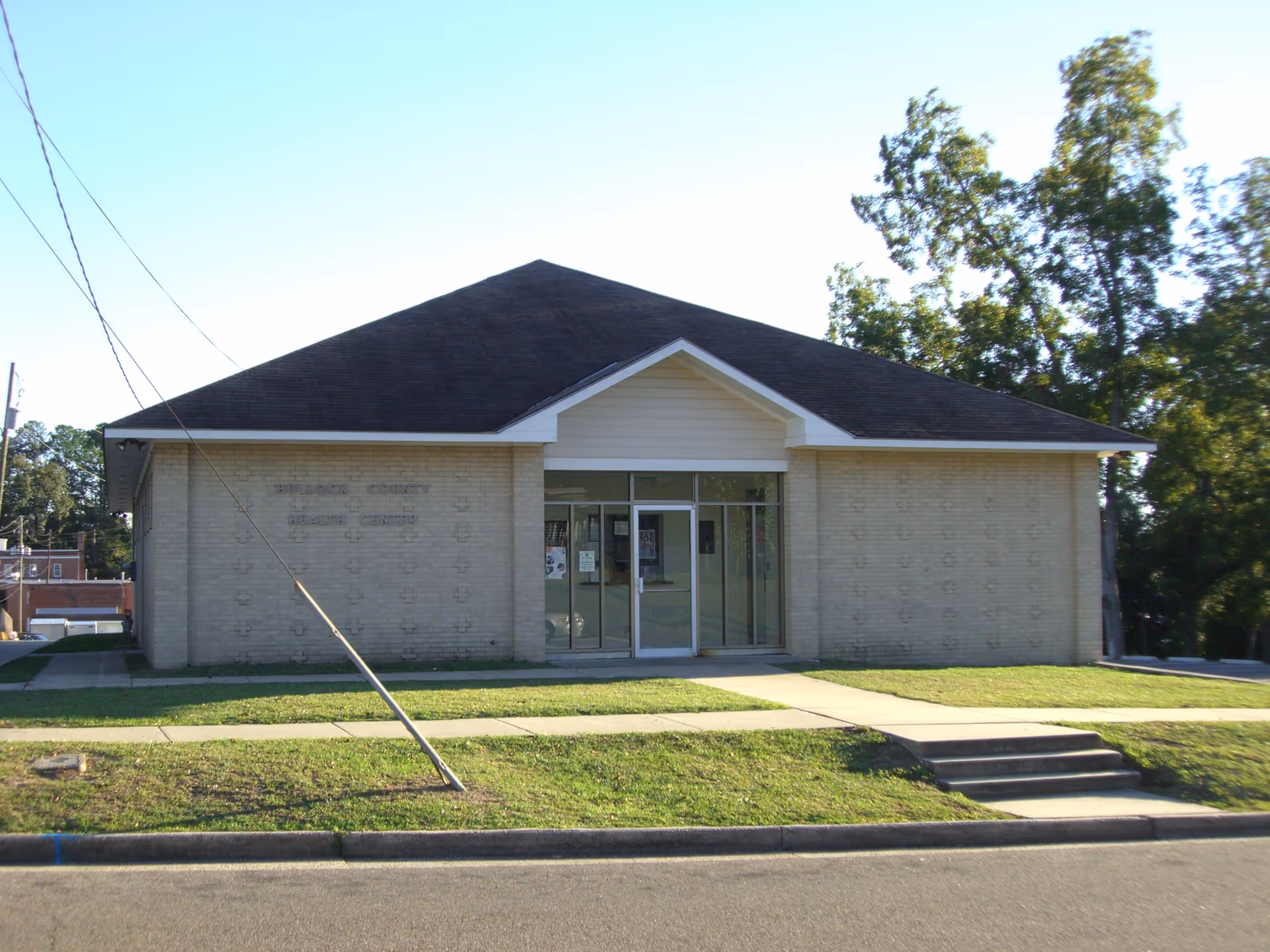 Front view of a single-story brick building with glass doors and steps.