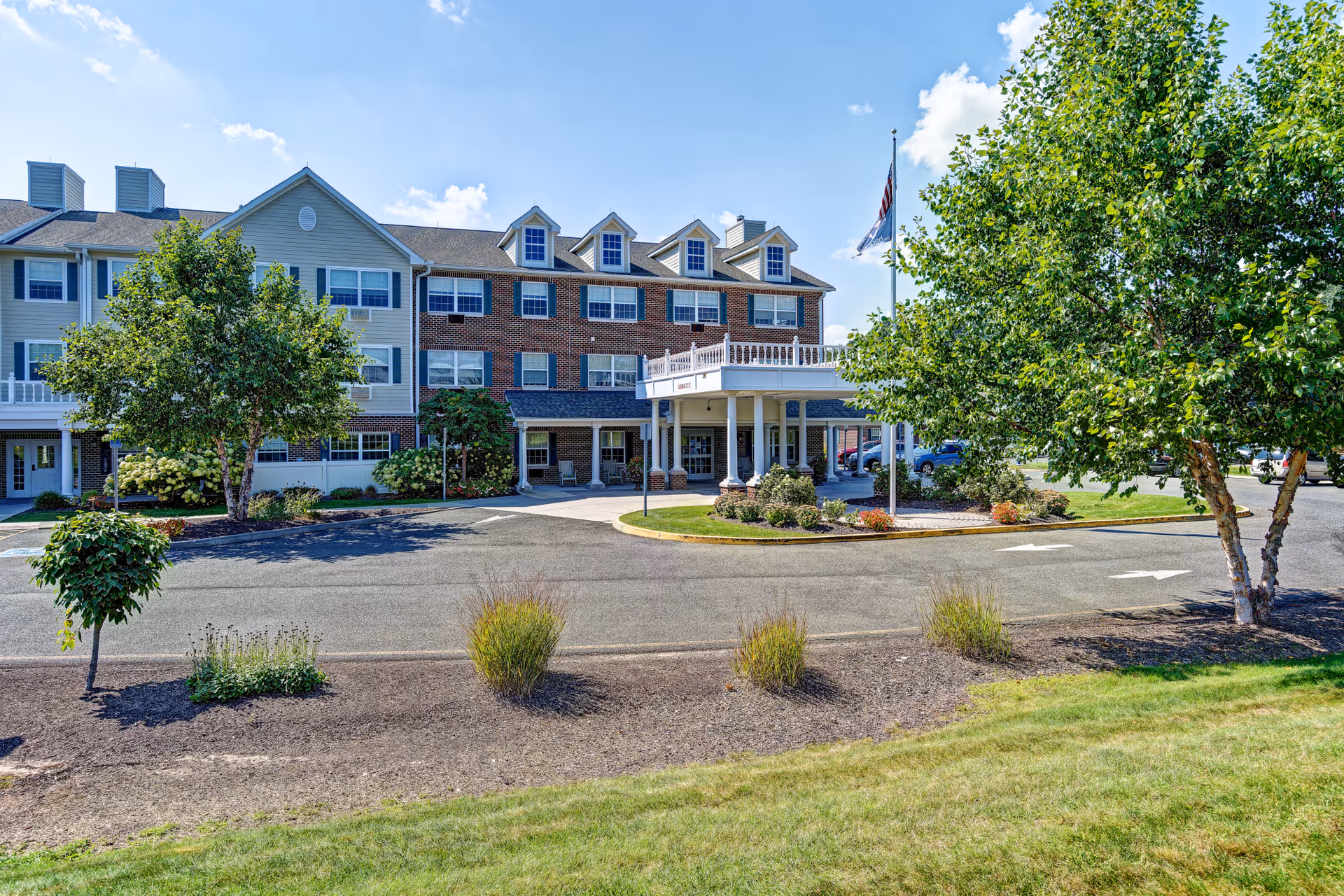 The Residence at Glastonbury exterior shows a brick-siding building with landscaped entrance.