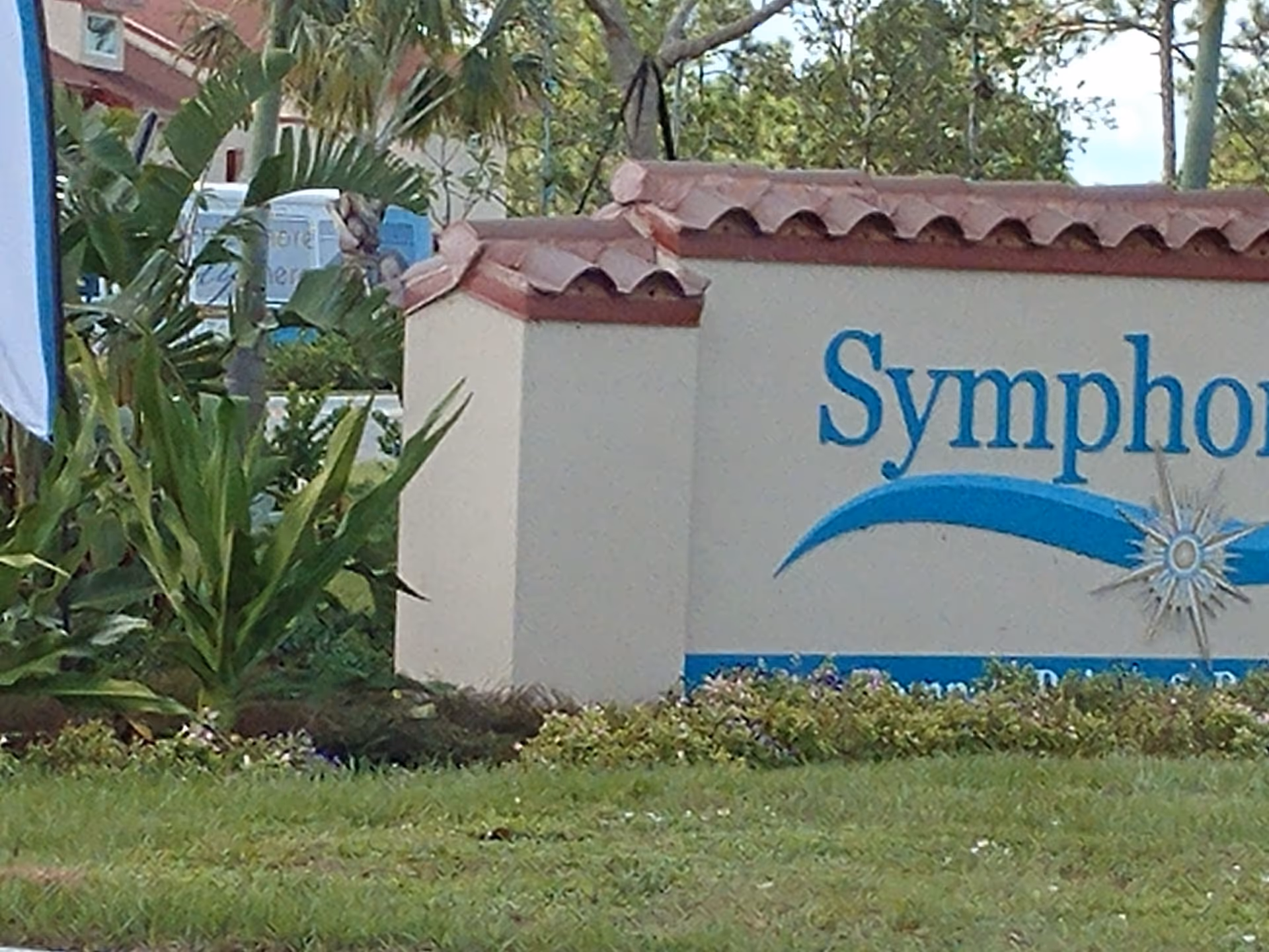 Symphony at Stuart entrance sign visible with landscaping and a blue sun emblem