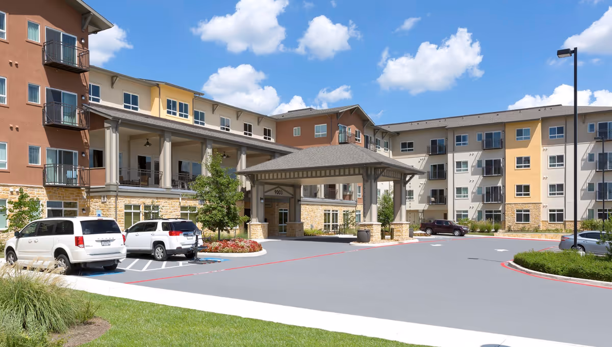 Exterior view of Affinity at Monterrey Village showing a multi-story residential building and entrance.