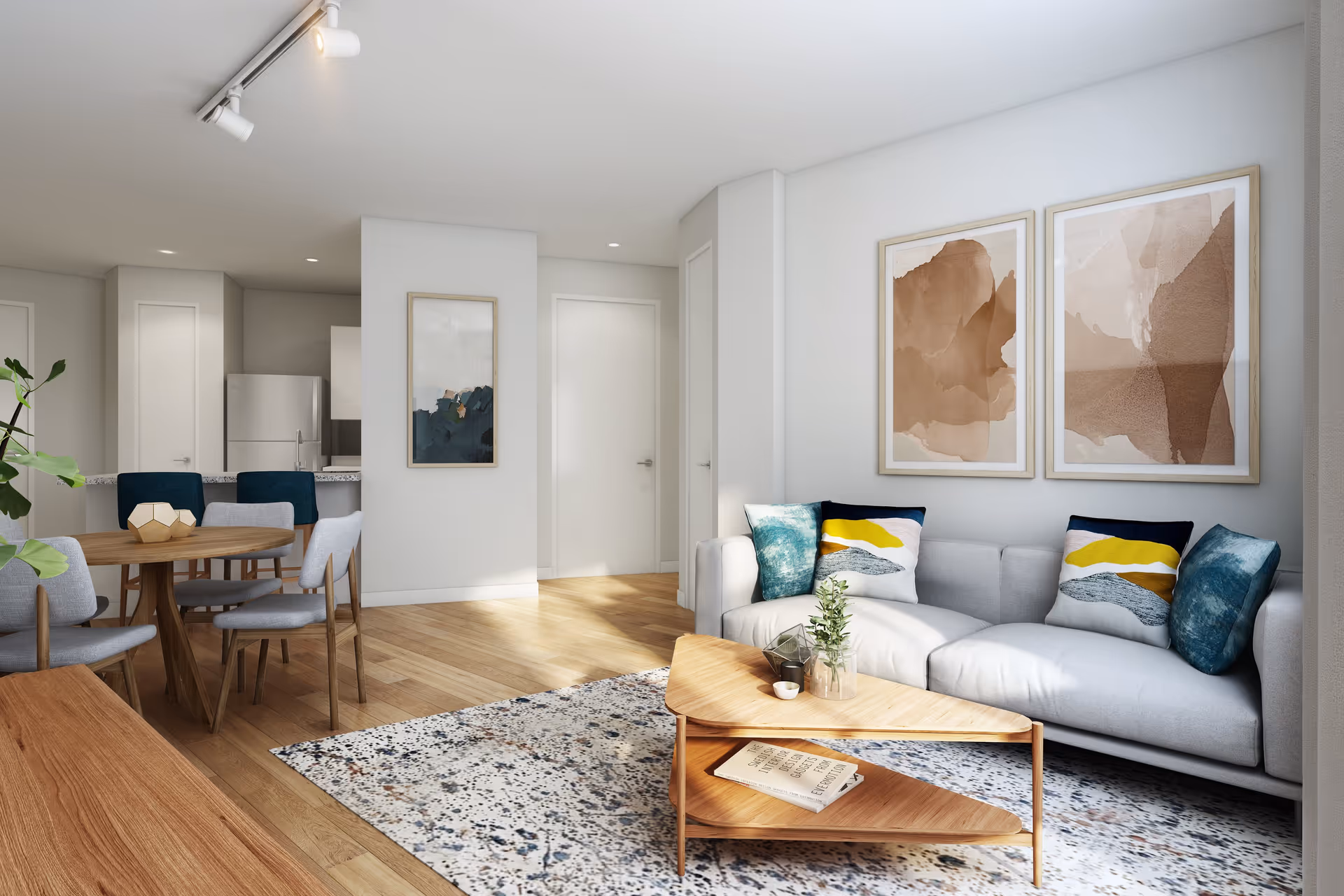 Bright open-concept living room with a gray sofa, wooden coffee table, dining table, and an open kitchen in the background.