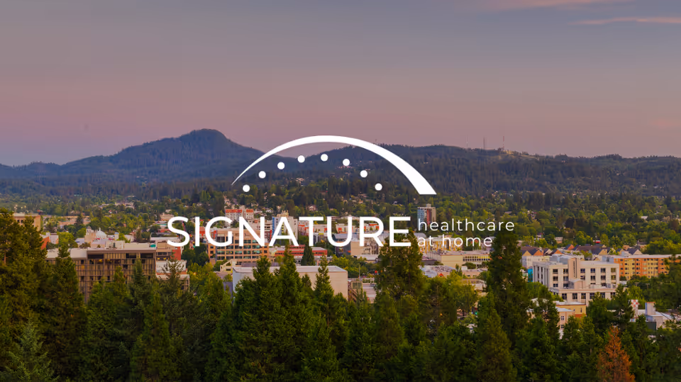 Cityscape with trees in foreground and a Signature healthcare at home logo overlay.
