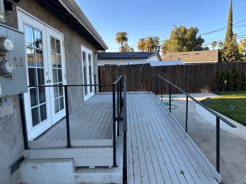 Back exterior of Elder Joy Oasis with ramped deck and glass doors.