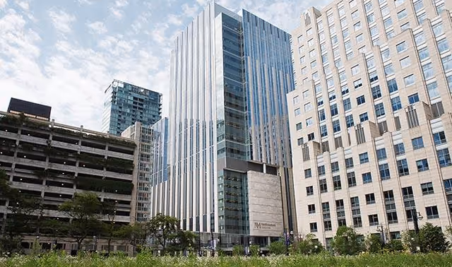 Exterior view of Northwestern Memorial Hospital Infusion Center complex with tall glass towers.