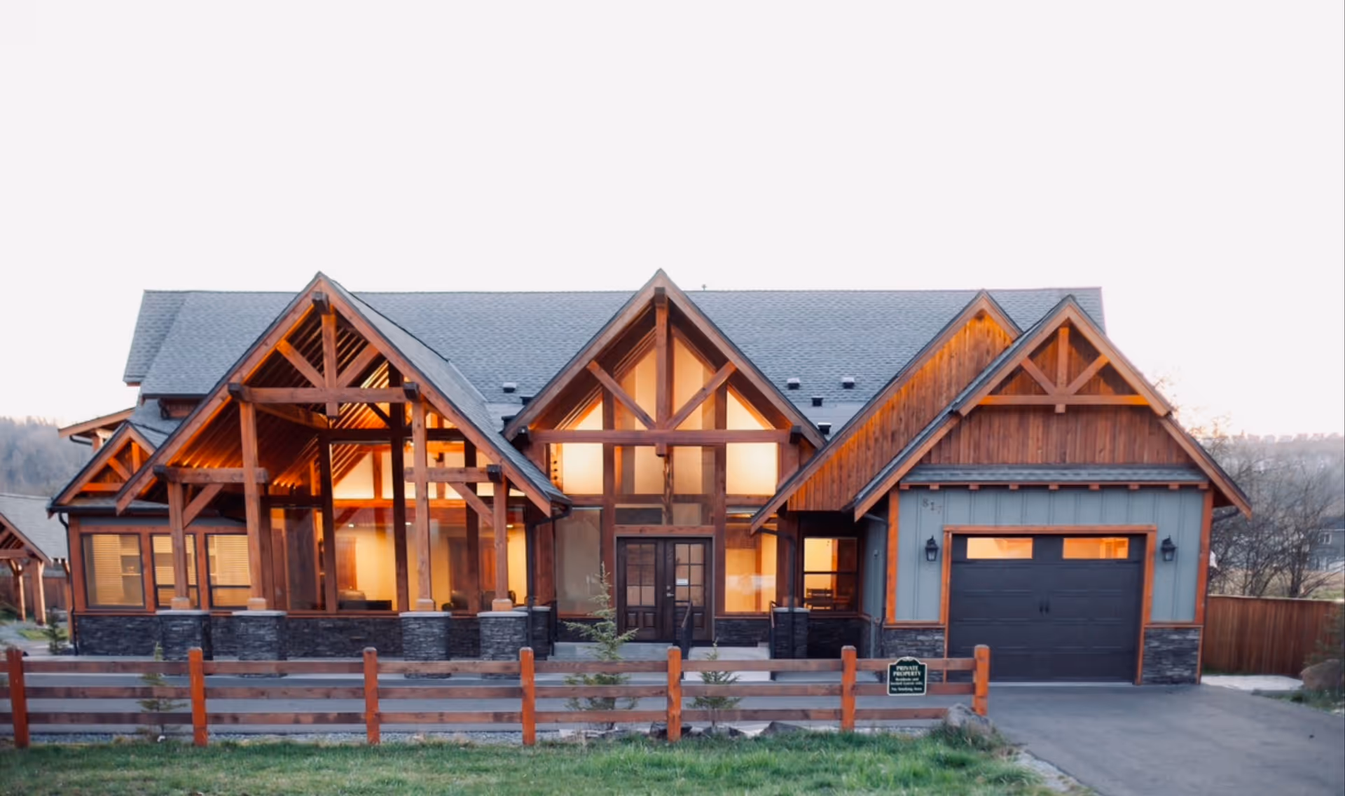 Rustic, multi-gabled house-style building with exposed timber framing and a wooden fence.