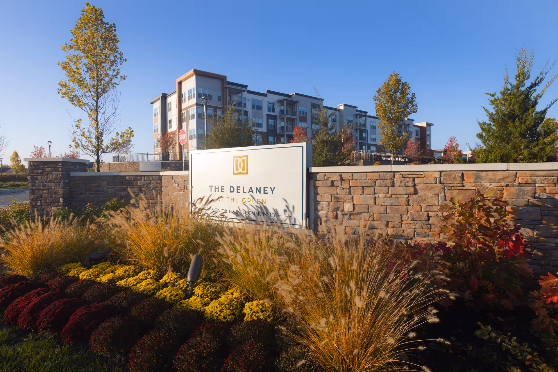 The Delaney at the Green sign in front of a modern multi-story building.