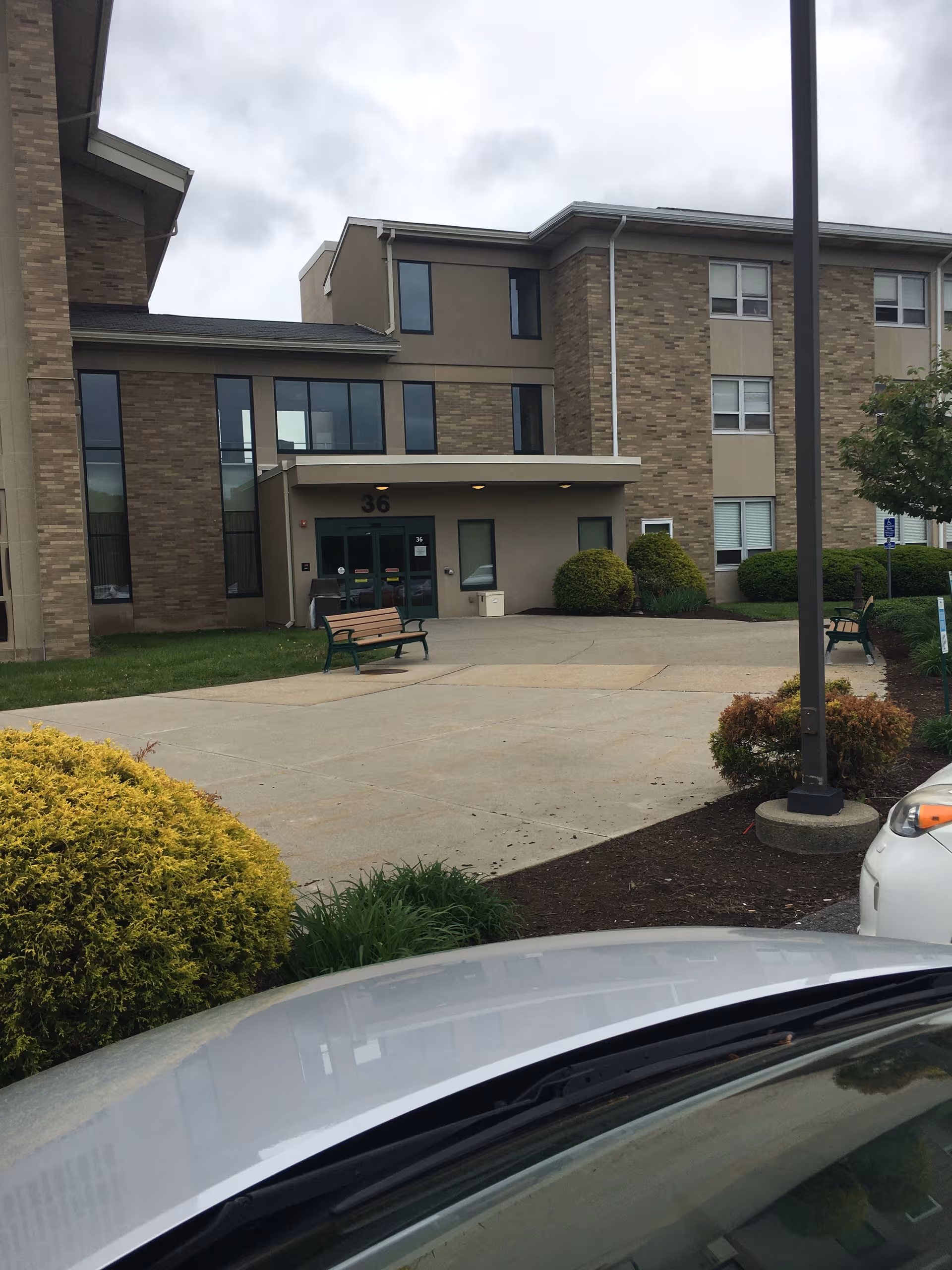 Exterior view of Mont Marie Rehabilitation and Healthcare Center entrance with benches.