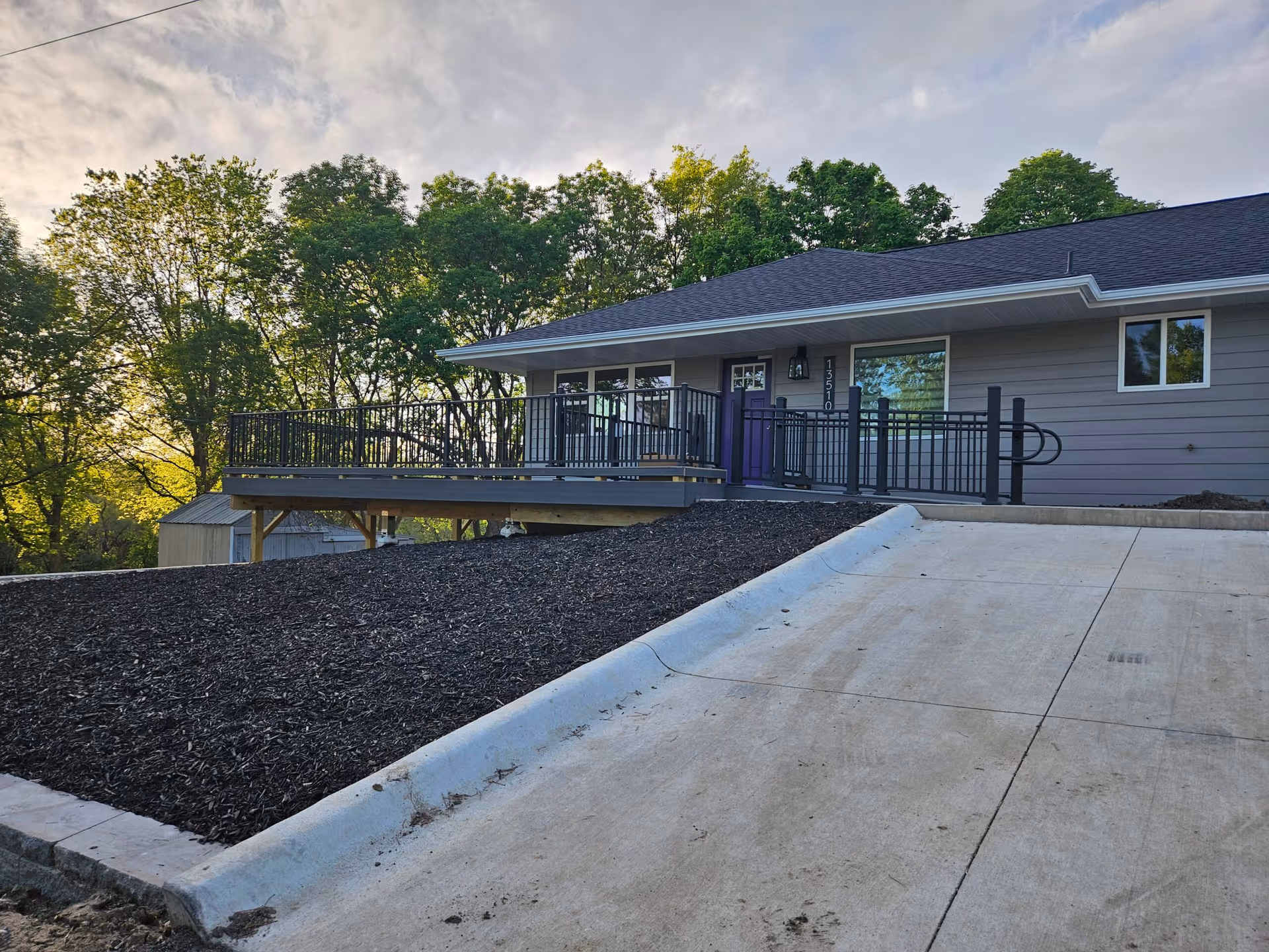 Exterior of a single-story senior living facility with a raised deck and accessible ramp.