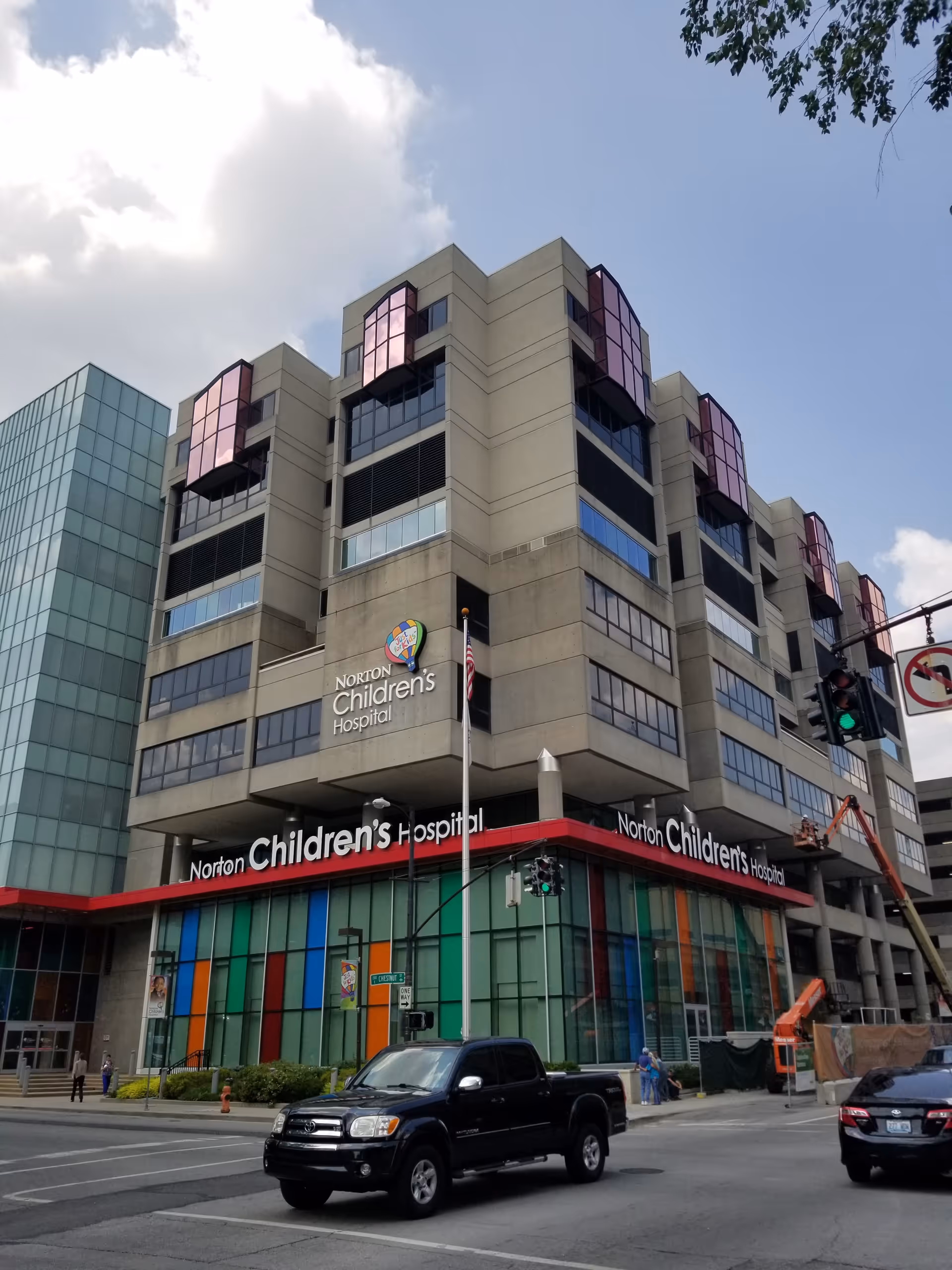 Multi-story hospital building with Norton Children's Hospital signage along a city street.