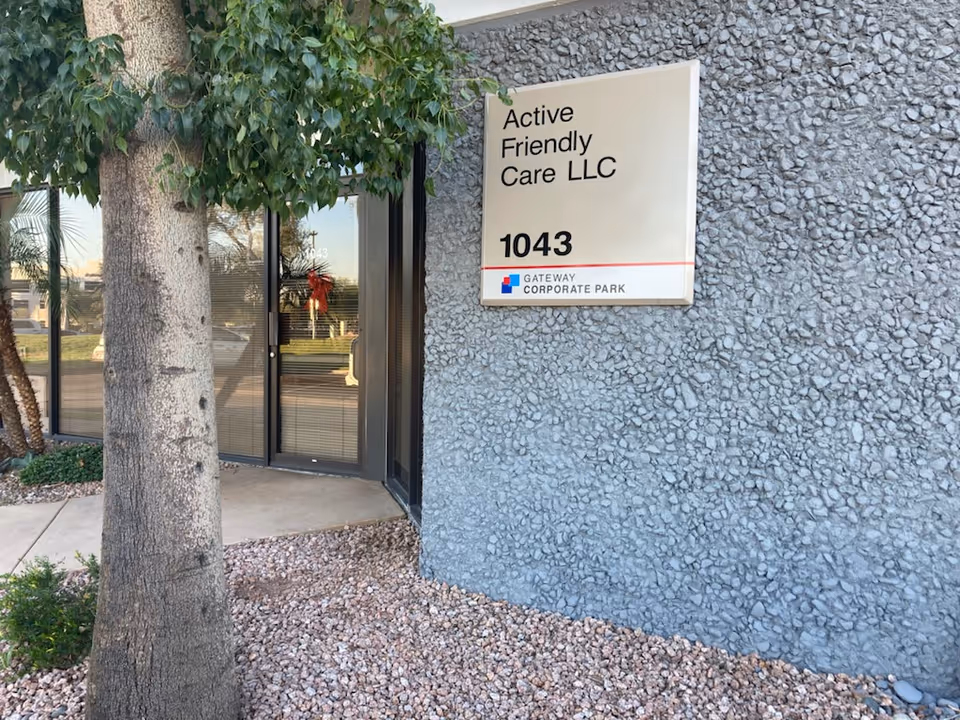 Exterior view of a gray textured building with a sign reading Active Friendly Care LLC.