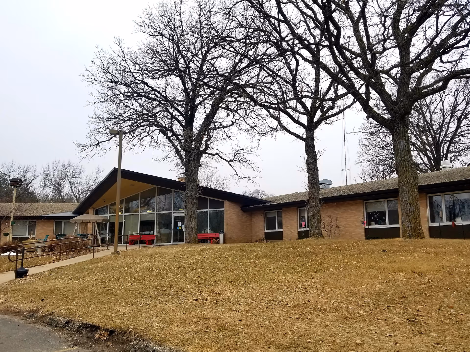 Exterior view of Glenoaks Senior Living Campus entrance with leafless trees outside.
