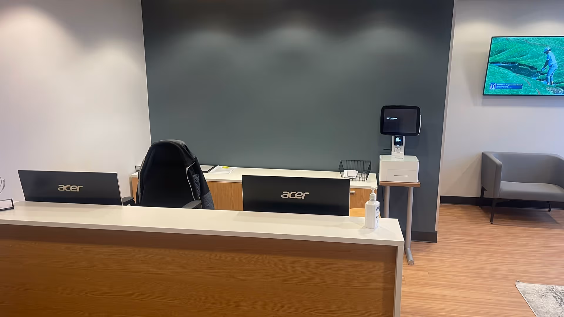 Interior Lifebridge Care LLC lobby with Acer monitors, sanitizer, and seating area.