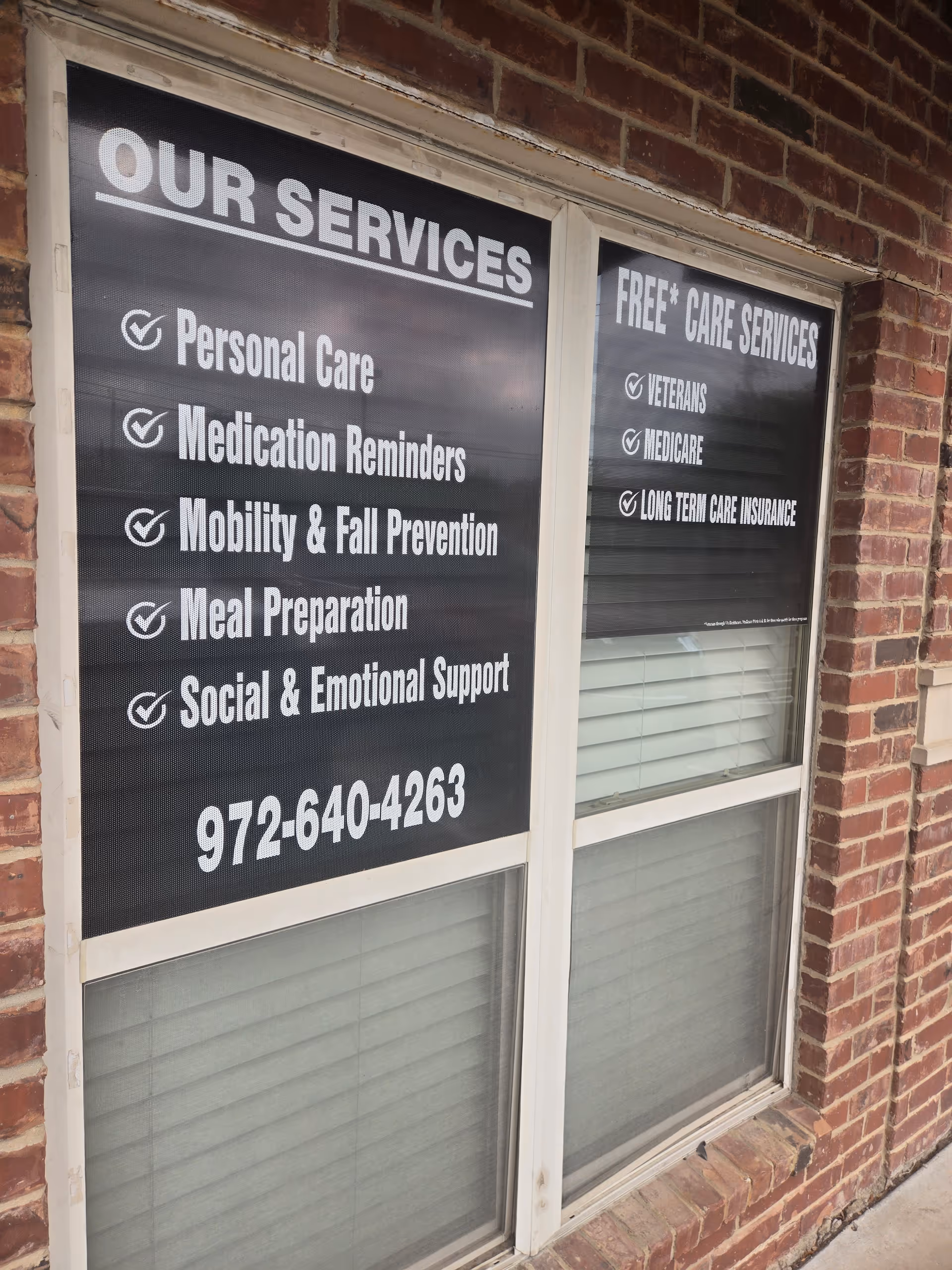 Bricked storefront with large window signs advertising Assisting Hands elder care services.