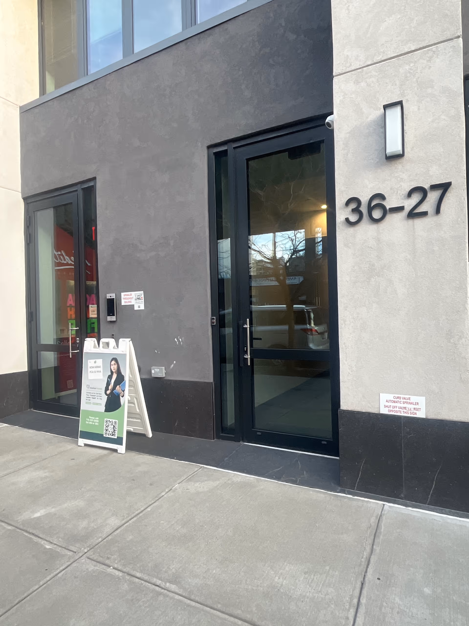 Exterior front entrance of Anchor Health Homecare with glass doors and large numbers.