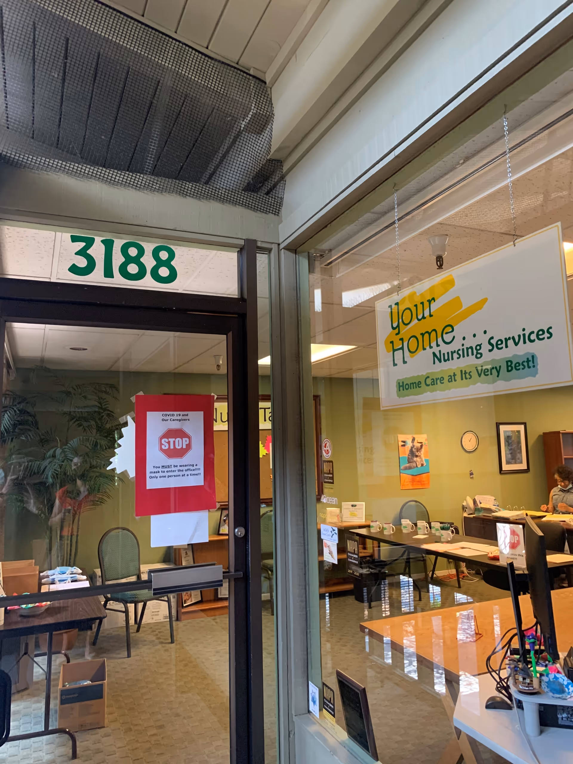 Indoor lobby of Your Home Nursing Services featuring reception desk, signage, and front entry.