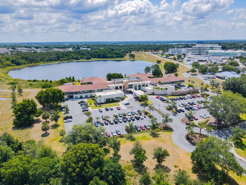 Aerial view of Solaris Healthcare Waterman campus with buildings, parking, and a surrounding lake.