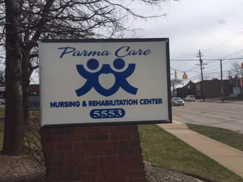Parma Care sign for Nursing & Rehabilitation Center along a street.
