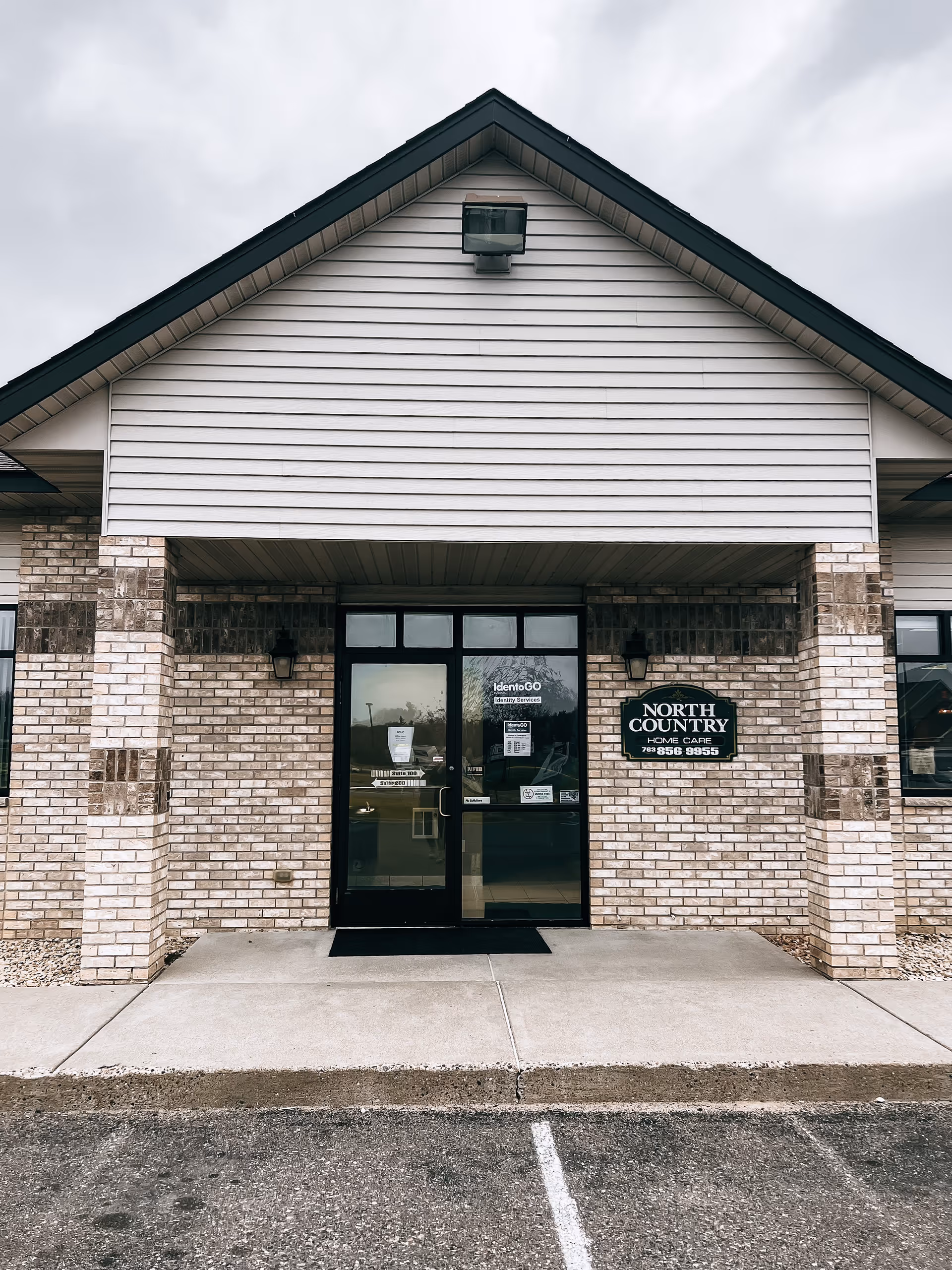 Front view of a brick building with glass doors and a North Country Home Care sign.