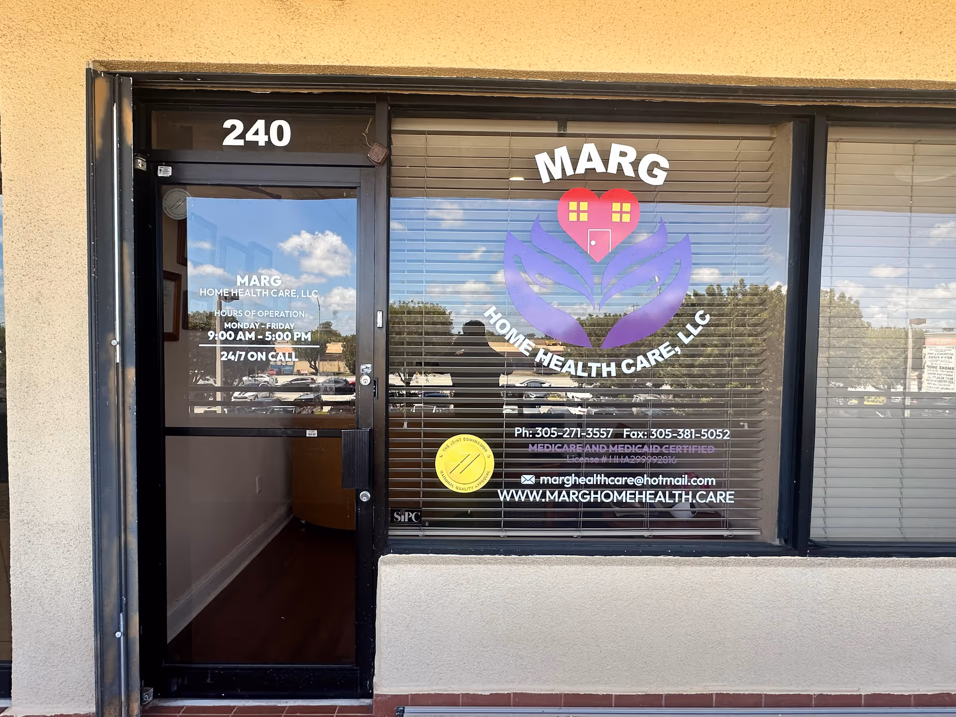 Storefront of Marg Home Health Care, LLC with logo on glass door and window, 240