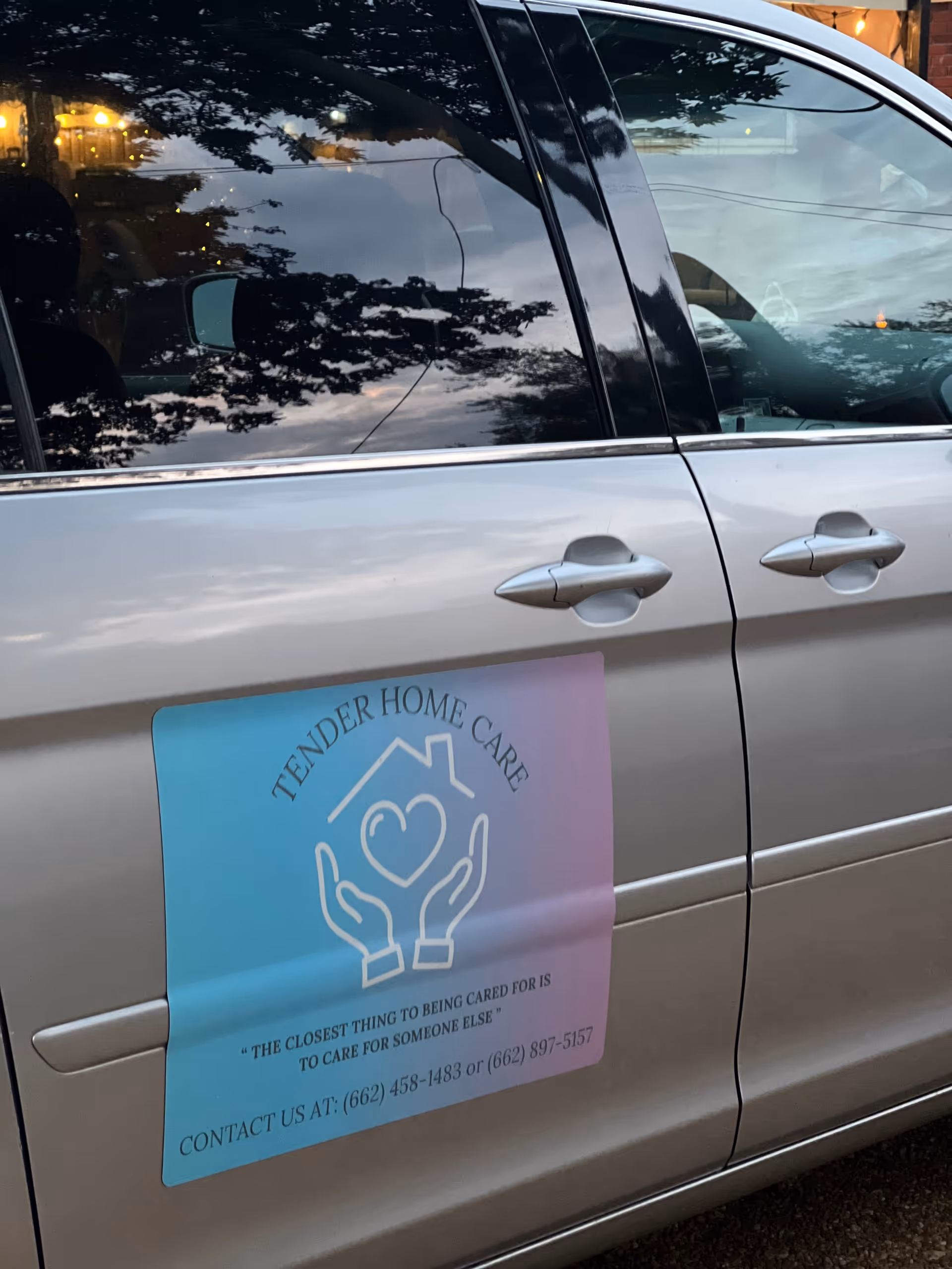 Silver van with Tender Home Care sticker and logo on the side.