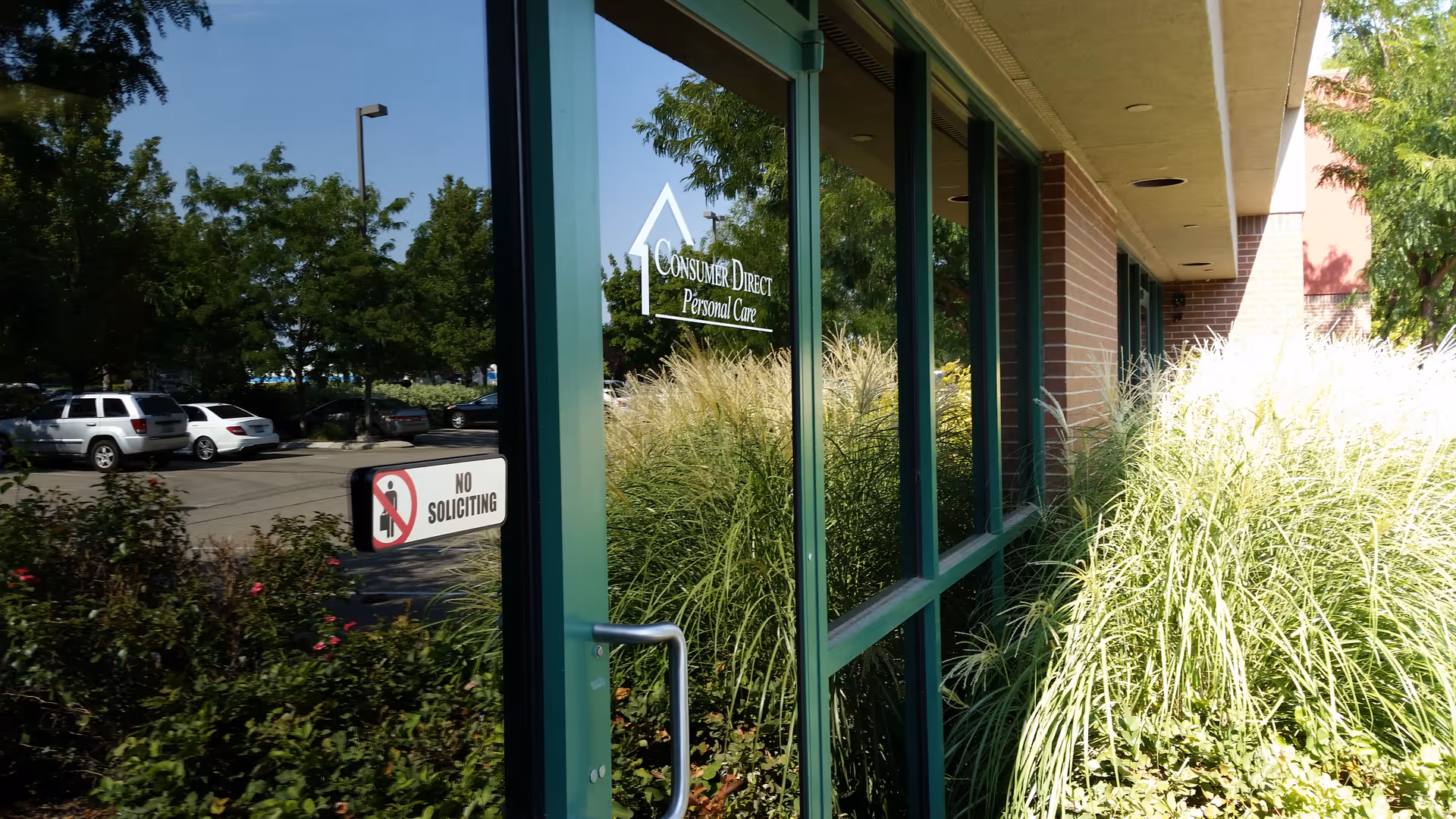 Exterior view of Consumer Direct Personal Care entrance with glass doors.