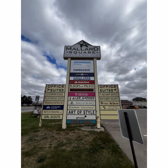 Tall outdoor signboard at Mallard Square lists OhioHealth Home Health with Compassus.