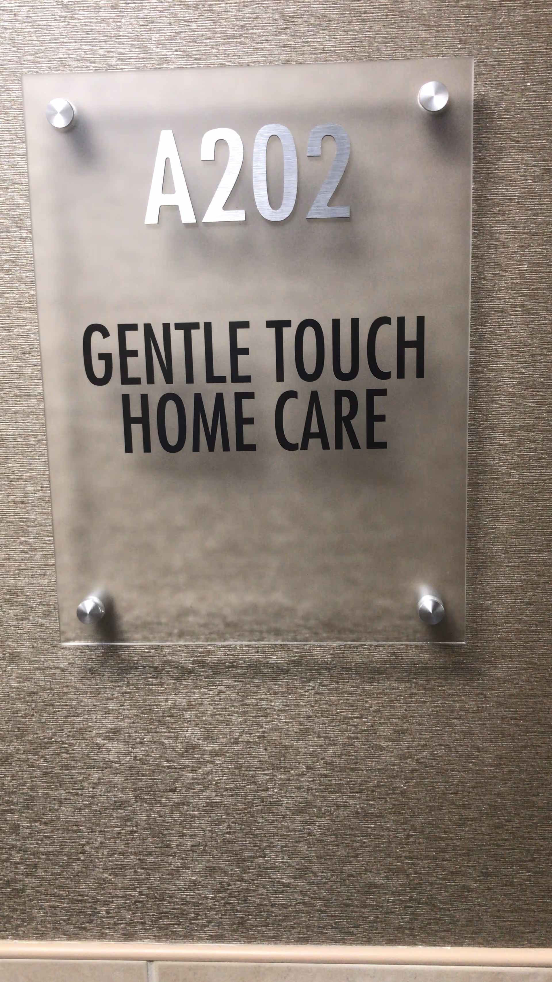 Interior wall plaque reads A202 Gentle Touch Home Care.