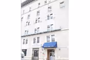 Exterior view of a multi-story brick building with a blue entrance canopy labeled Oxford Nursing Home.