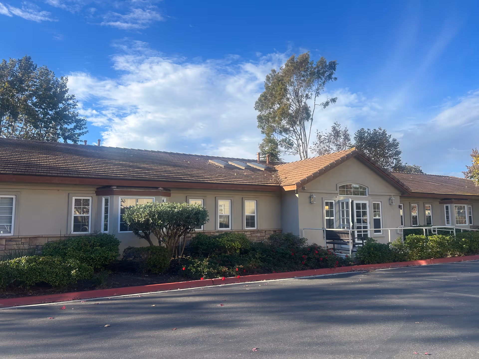 Everest at Oceanside exterior building with landscaped shrubs and blue sky.