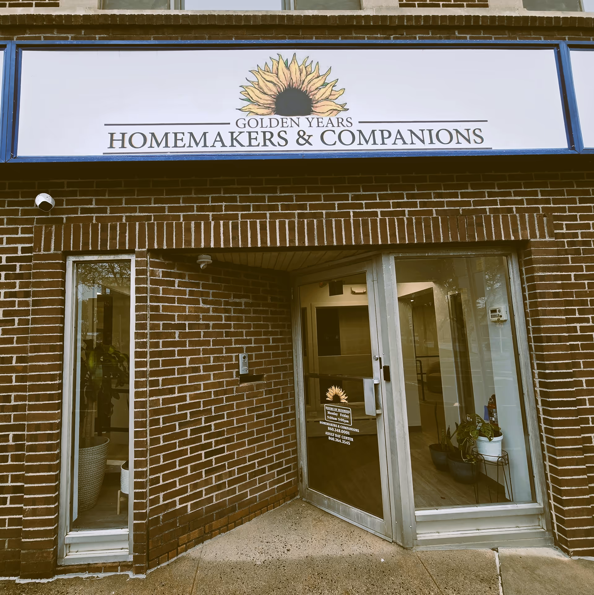 Front entrance of a brick building with a sign for Golden Years Homemakers & Companions