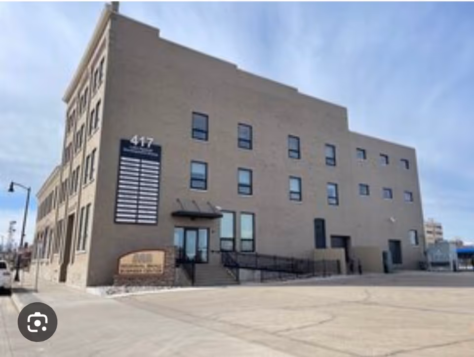 Exterior view of Kristina's Helping Hands, LLC facility, a multi-story brick building with front entrance.