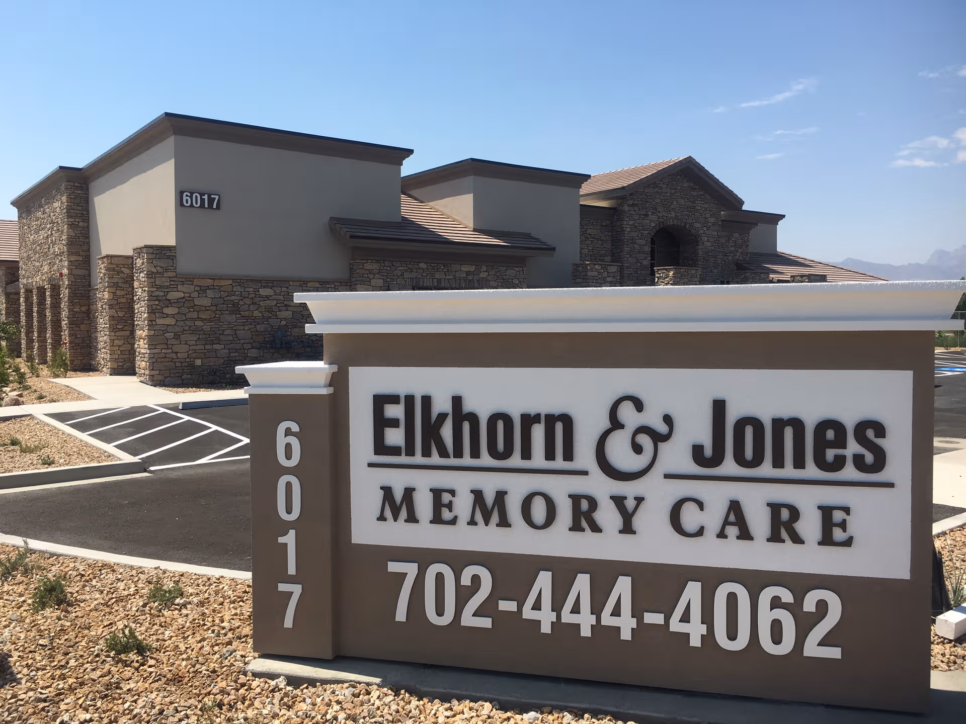 Front exterior of Elkhorn & Jones Memory Care with large sign and building facade.