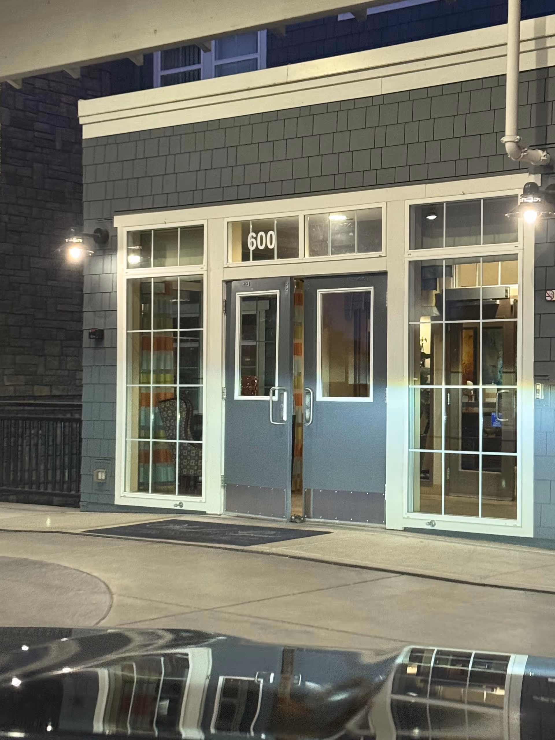 Exterior view of Waterford Grand entrance with blue double doors and large windows.