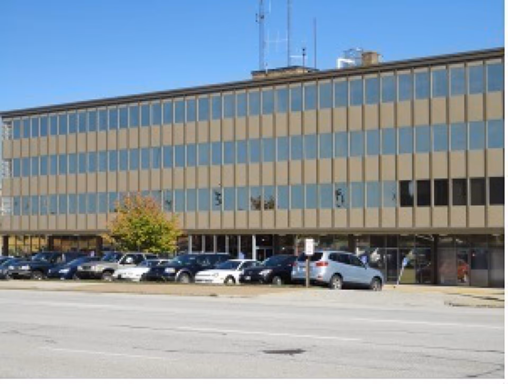 Front exterior of Ace Health & Hospice facility with a large parking lot
