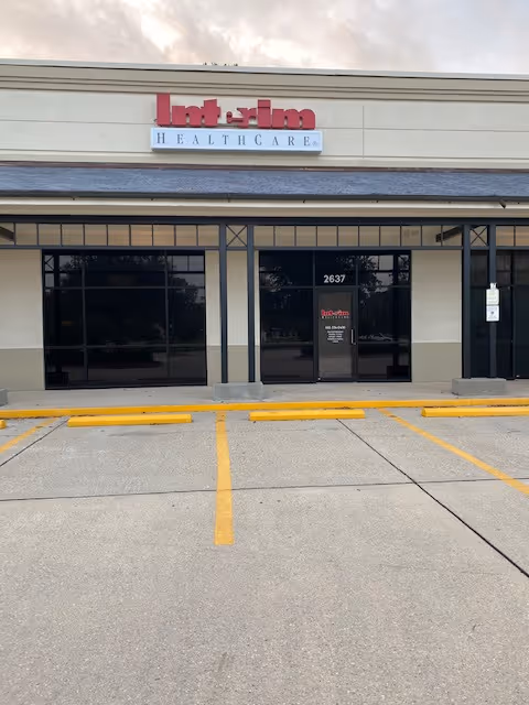Exterior view of Interim HealthCare of Mandeville storefront with glass doors and parking.