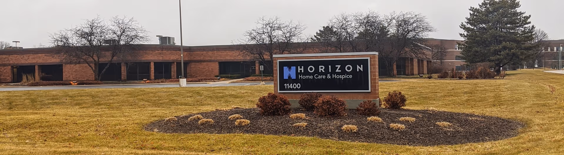 Front exterior view of Horizon Home Care & Hospice building with a landscaped sign.