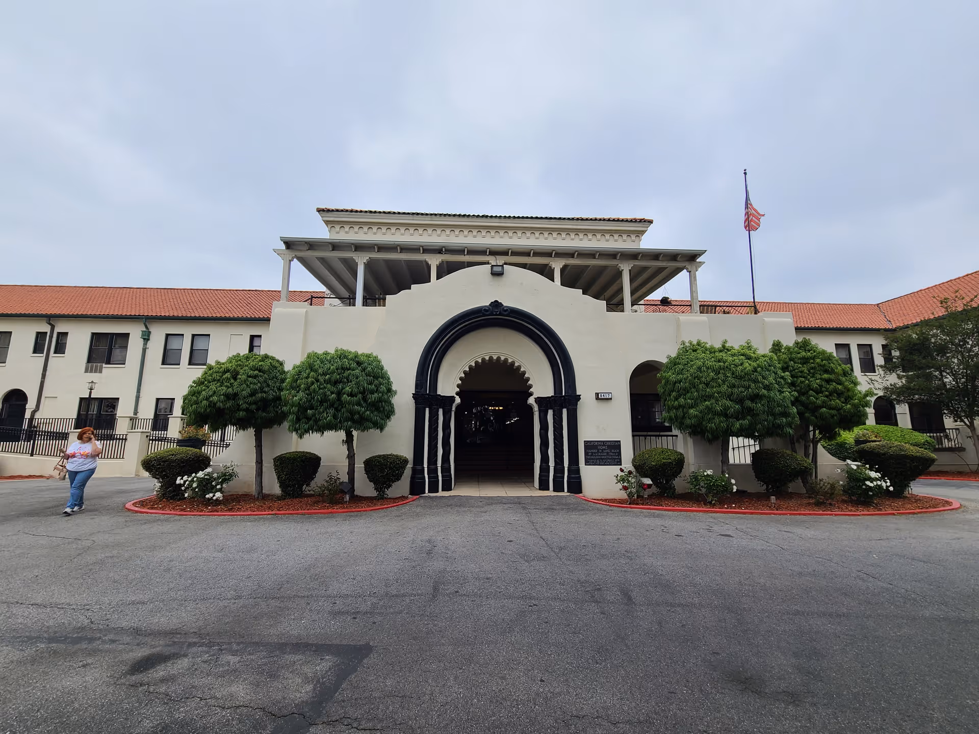 Front exterior of Mission Care and Rehabilitation Center with arched entrance and landscaped surroundings.