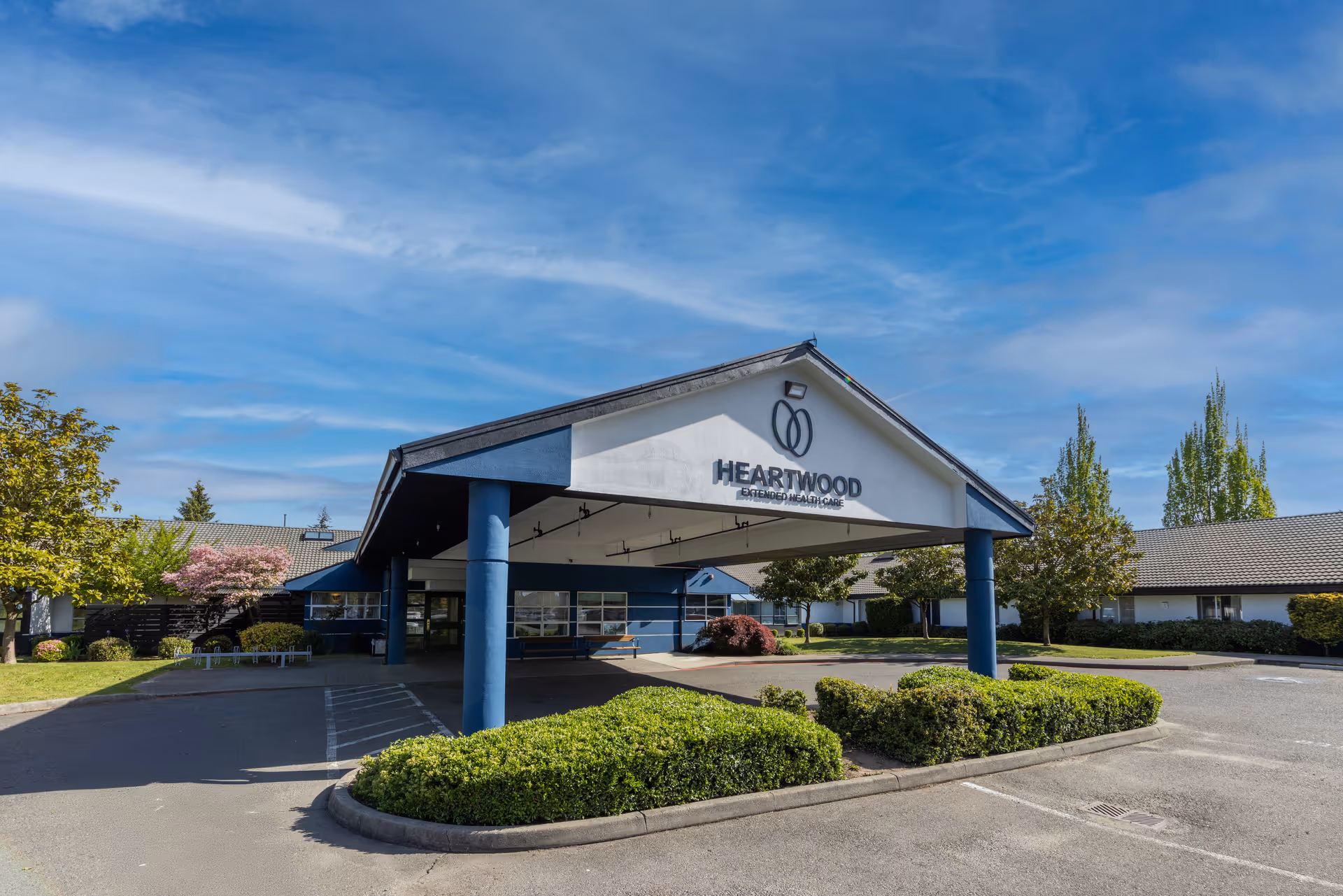 Exterior view of Heartwood Extended Health Care with covered entrance and landscaped drive.
