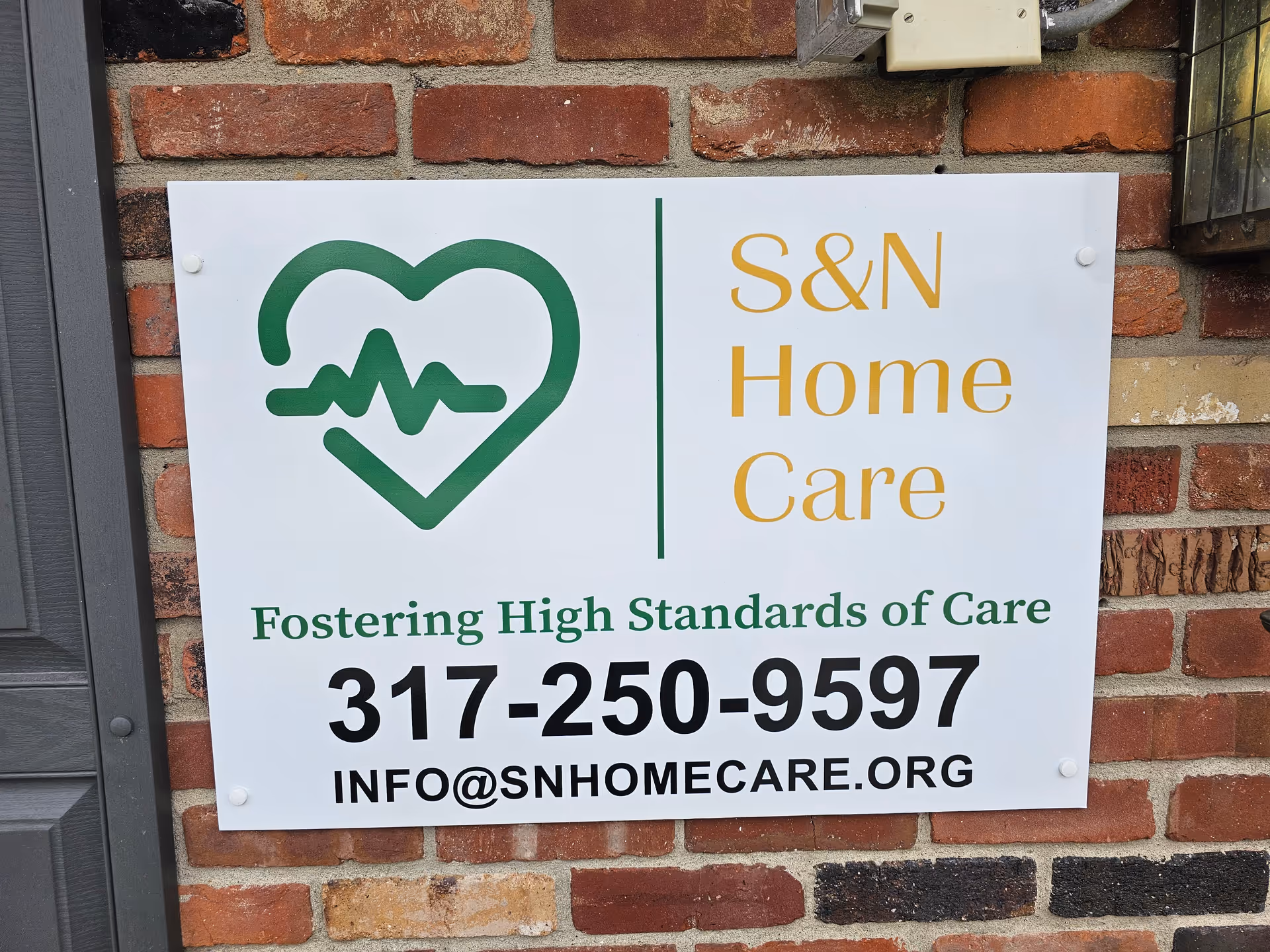 Sign on brick exterior wall advertising S&N Home Care.
