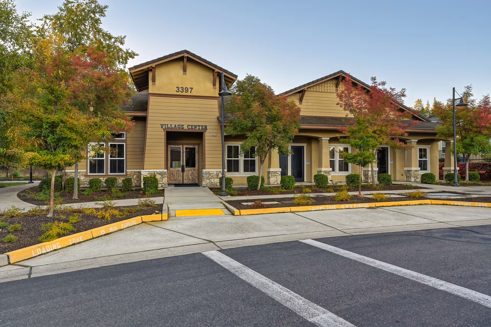 Exterior view of Eskaton Village Placerville building with trees and a parking area.