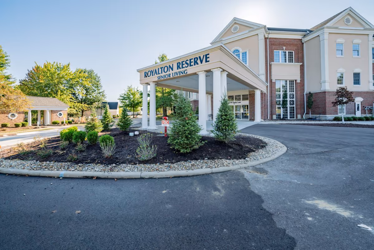Front view of Royalton Reserve Senior Living building with circular driveway and landscaped entrance.