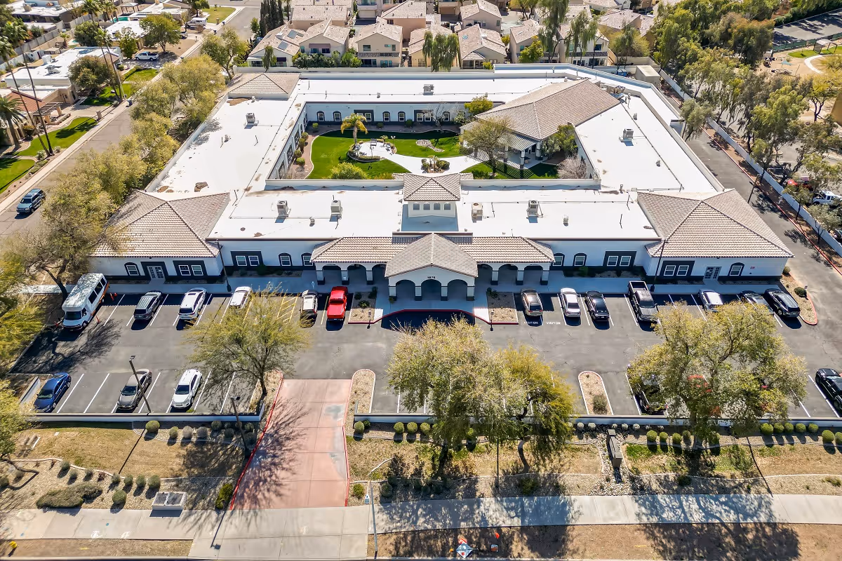 Aerial view of a large U-shaped senior living facility with a central courtyard.