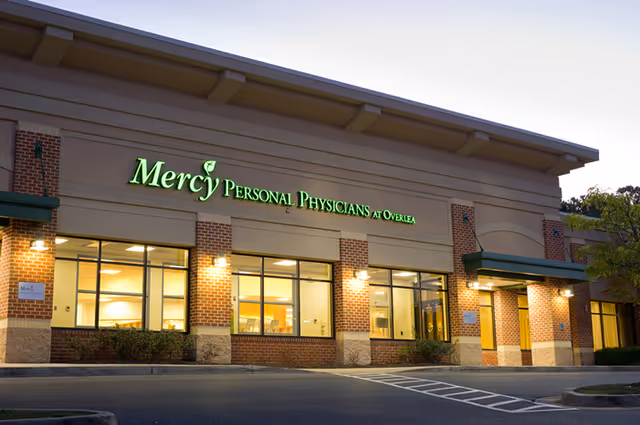 Exterior view of Mercy Personal Physicians at Overlea storefront with illuminated sign.