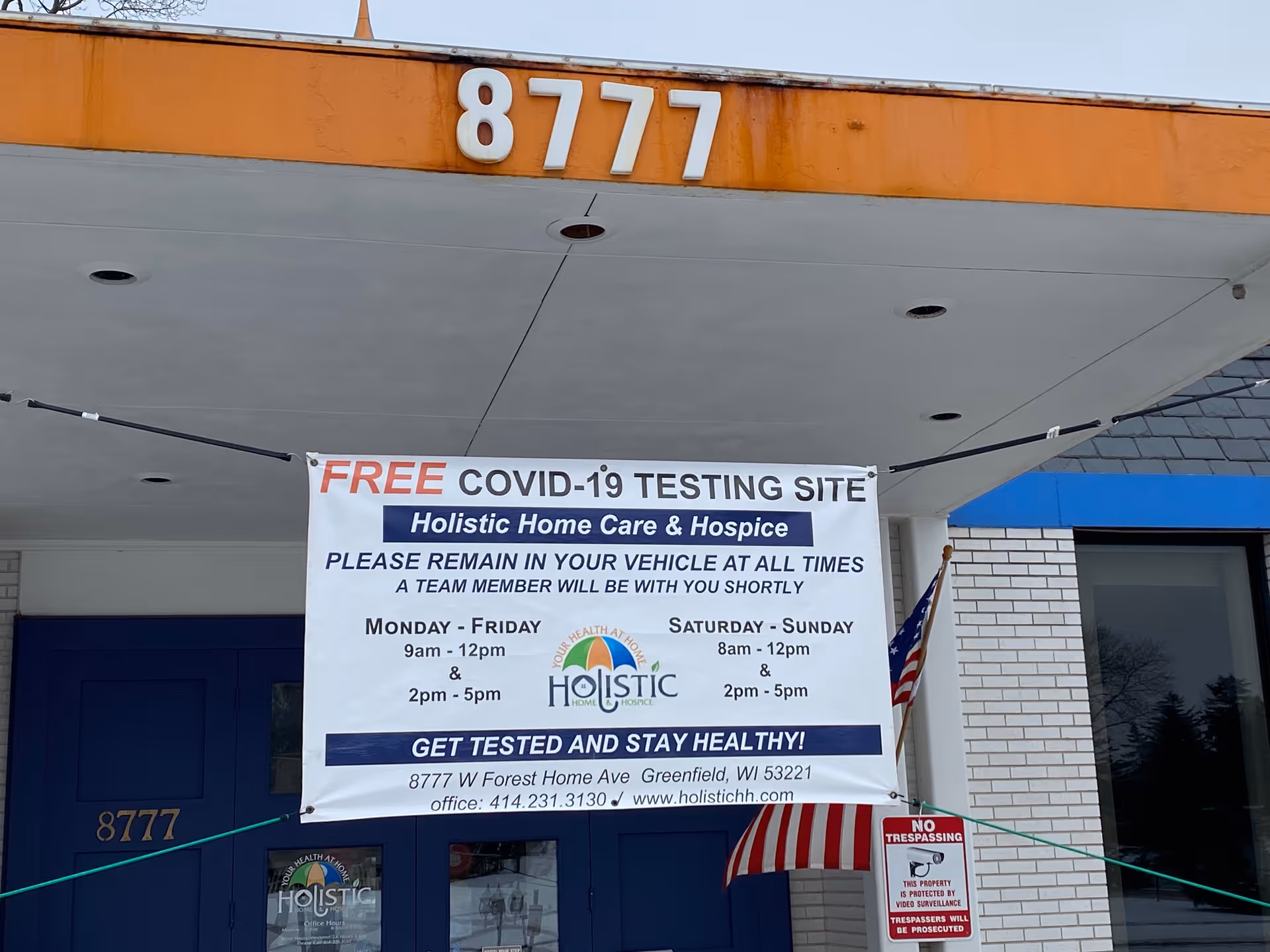 Exterior of a building with a large banner advertising free COVID-19 testing.