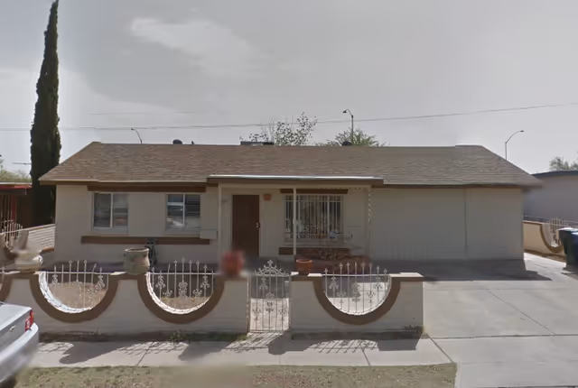 Front view of Betania Care Home, a single-story residence with a decorative curved fence.