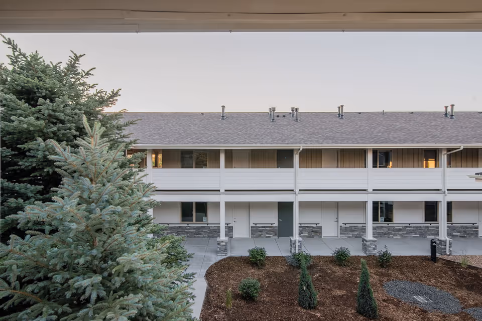 Exterior view of 2730 at Adeo senior living building with balconies and landscaping.