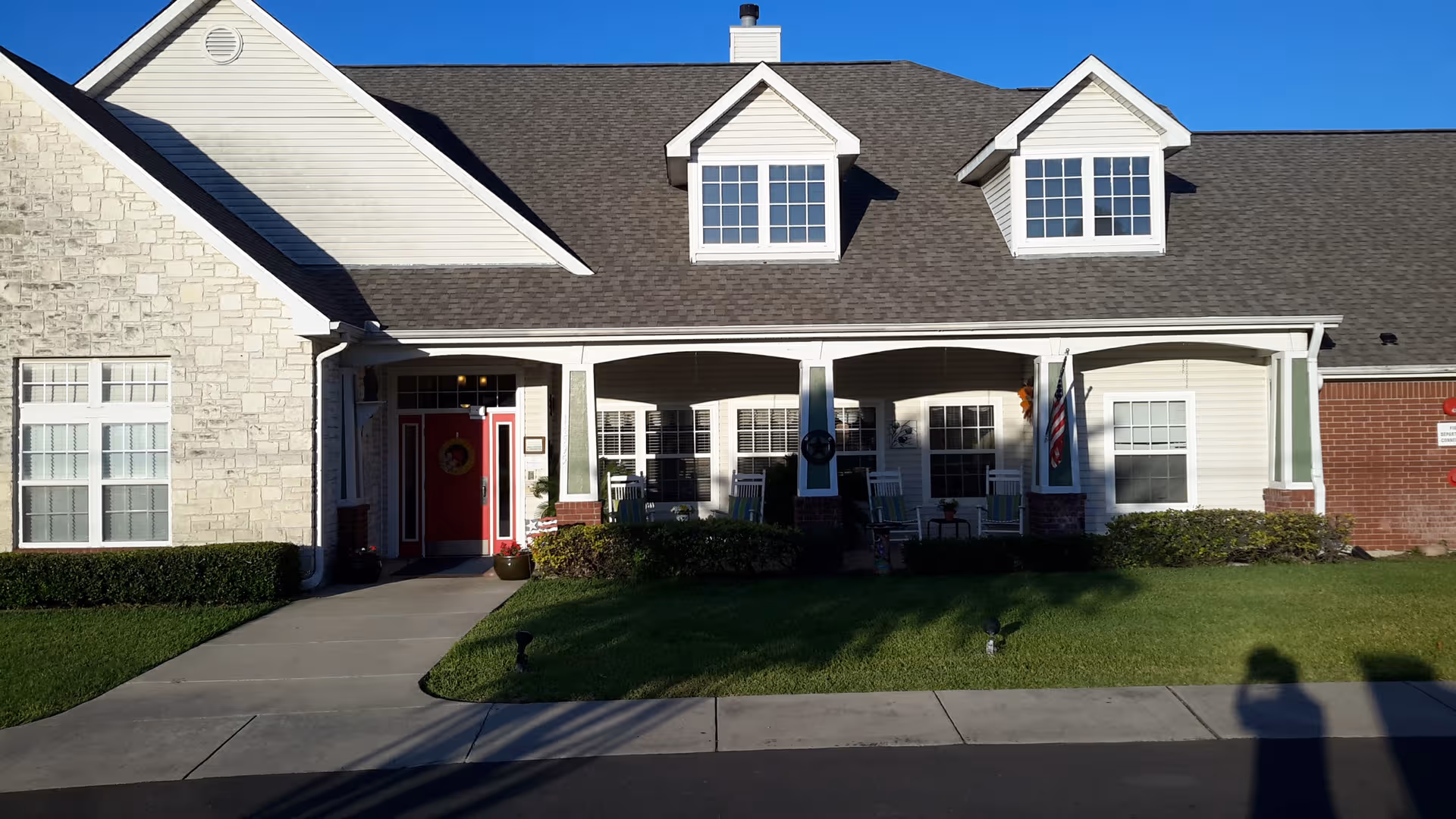 Front exterior of Brookdale Nacogdoches senior living building with porch and lawn.