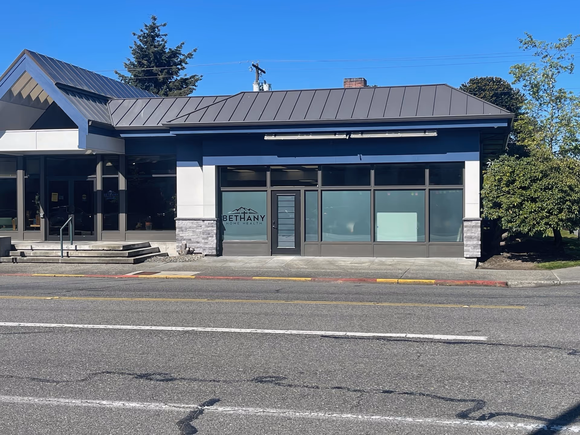 Exterior view of Bethany Home Health storefront along a street, with large windows.