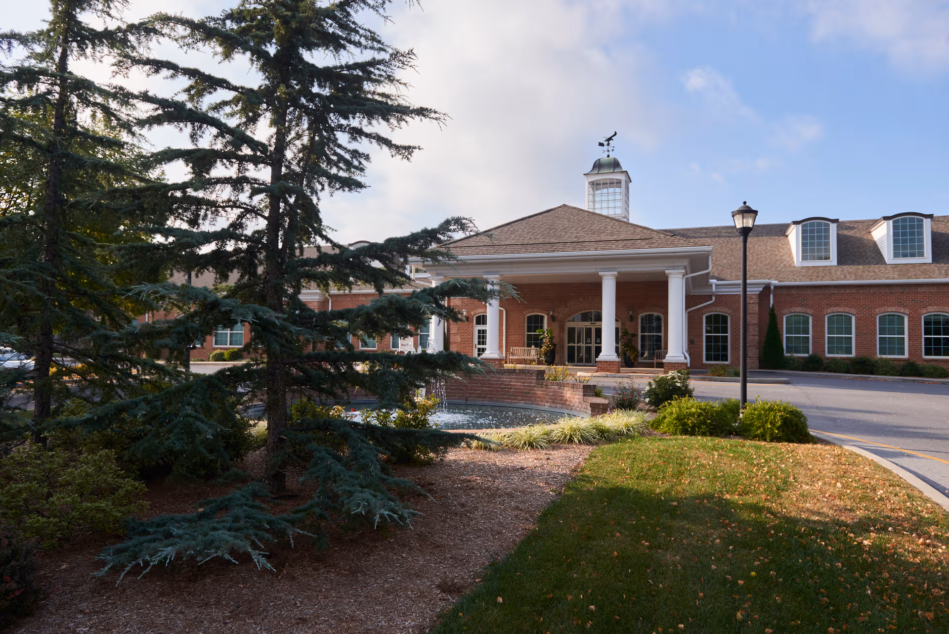 Exterior view of The Highlands at Wyomissing, brick building with a columned entrance.