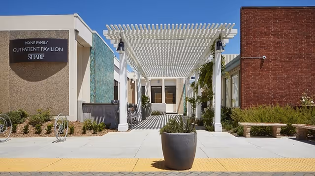 Exterior view of Sharp Coronado Payne Family Outpatient Pavilion entrance under a white pergola